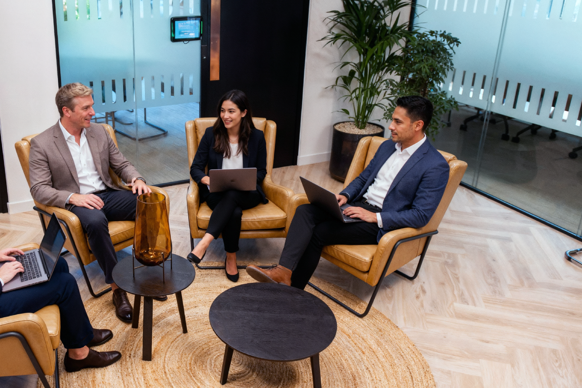Colleagues relaxing and working together in a stylish No5 Weybridge office lounge
