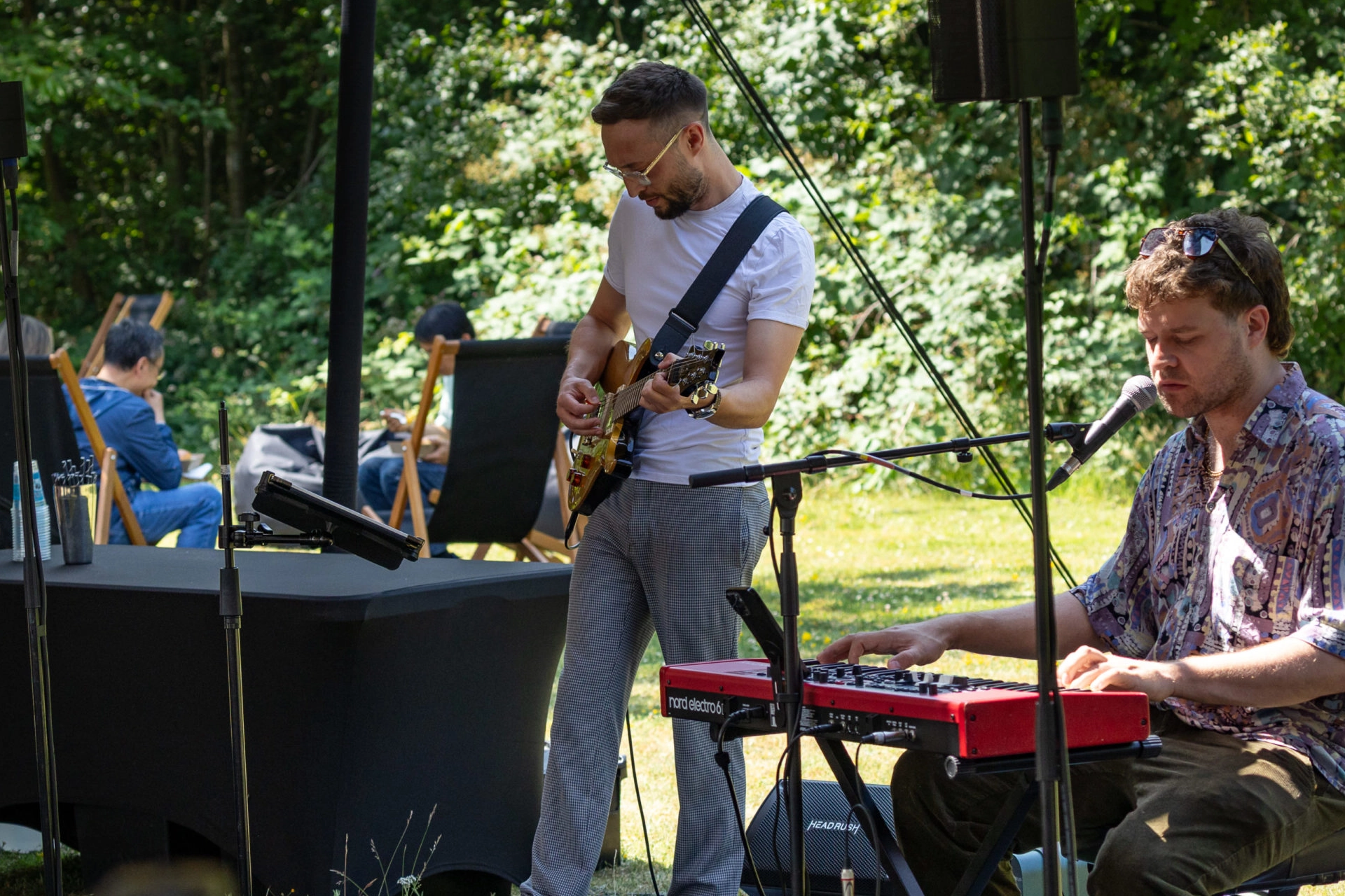 Musicians performing outdoors at a garden event